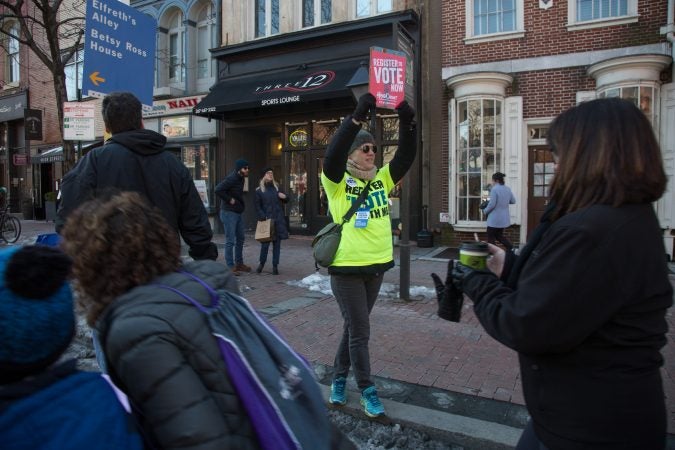 Volunteers with voting registration information and forms lined the march route as Philadelphians of all ages participated in the city's March for Our Lives, March 24, 2018. (Emily Cohen for WHYY)