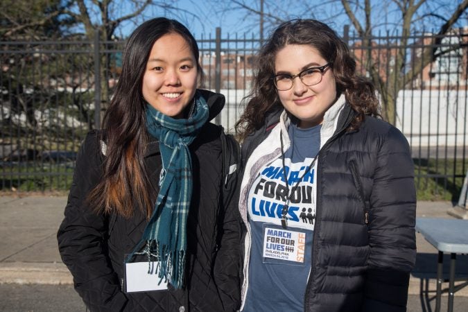 Grace Chong, 18, (left), stands with fellow student leader Rachel Steinig, 18. The University of Pennsylvania freshmen helped put together the rally aspect of the Philadelphia March for Our Lives, March 24, 2018. (Emily Cohen for WHYY)