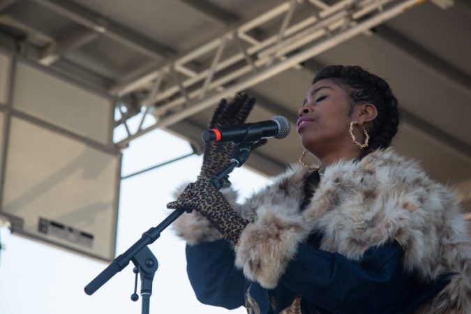 Suzann Christine, a Philadelphia musician, sings to the crowd gathered at the Philadelphia March for Our Lives, March 24, 2018. (Emily Cohen for WHYY)