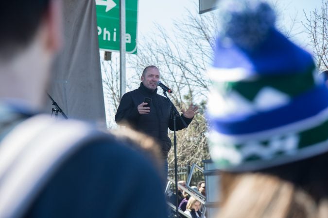 A father of a surviving 9th grader Marjory Stoneman Douglas High School recounts how he legally bought an AR-15 just two years ago and how he gave it in to police after the shooting at his son's school to the crowd gathered at the Philadelphia March for Our Lives, March 24, 2018. (Emily Cohen for WHYY)