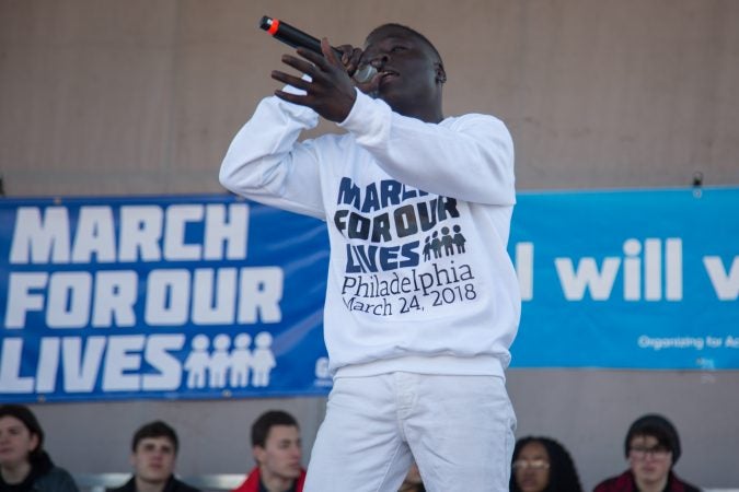 Devontay Crawford, 18, performs an original song for the crowd gathered at in Philadelphia to participate in the March for Our Lives, March 24, 2018. (Emily Cohen for WHYY)