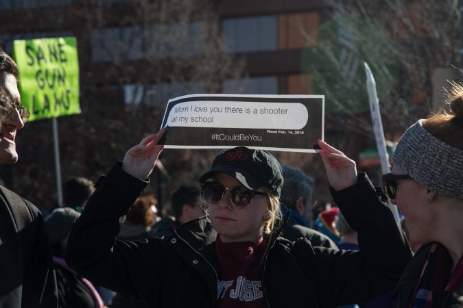 Teens got creative with their signs at the Philadelphia March for Our Lives, March 24, 2018. (Emily Cohen for WHYY)