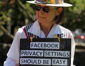 Mary Guedon of the group Raging Grannies holds a sign as she protests in 2010 outside of the Facebook headquarters in California. Privacy advocates say it's too difficult to fully protect your privacy on Facebook.
(Justin Sullivan/Getty Images)