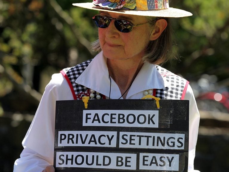 Mary Guedon of the group Raging Grannies holds a sign as she protests in 2010 outside of the Facebook headquarters in California. Privacy advocates say it's too difficult to fully protect your privacy on Facebook.
(Justin Sullivan/Getty Images)