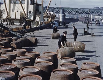 Workers roll barrels of Guinness in June 1955 on a quayside in Dublin. (Bert Hardy/Getty Images)
