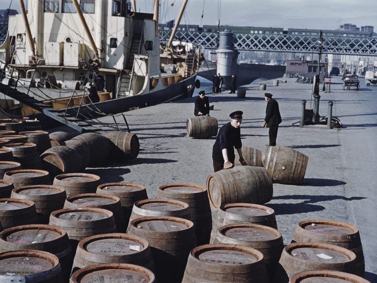 Workers roll barrels of Guinness in June 1955 on a quayside in Dublin. (Bert Hardy/Getty Images)