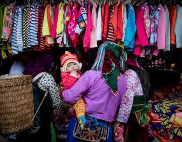 Shoppers explore the goods on display in Ha Giang, Vietnam. The country's textile industry was expected to be one of the biggest winners from the Trans-Pacific Partnership, which would have provided tariff-free access to U.S. markets. Under the new agreement, the industry is still expected to gain — if not nearly as much. (Linh Pham/Getty Images)