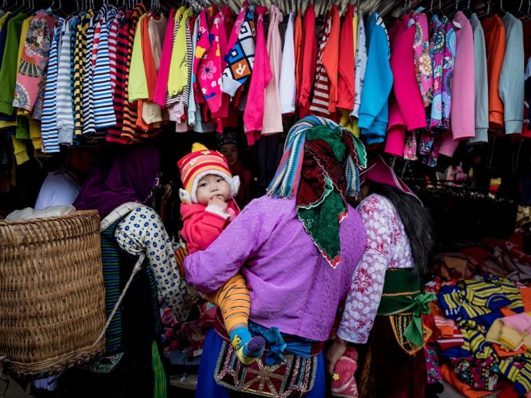 Shoppers explore the goods on display in Ha Giang, Vietnam. The country's textile industry was expected to be one of the biggest winners from the Trans-Pacific Partnership, which would have provided tariff-free access to U.S. markets. Under the new agreement, the industry is still expected to gain — if not nearly as much. (Linh Pham/Getty Images)