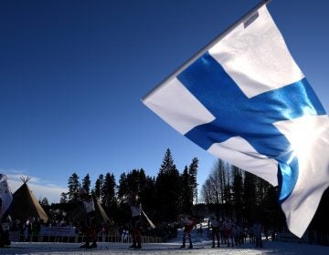 A fan waves the Finnish flag during the Nordic World Ski Championships last year. Finland is No. 1 on the annual World Happiness Report, released Wednesday. (Matthias Hangst/Getty Images)