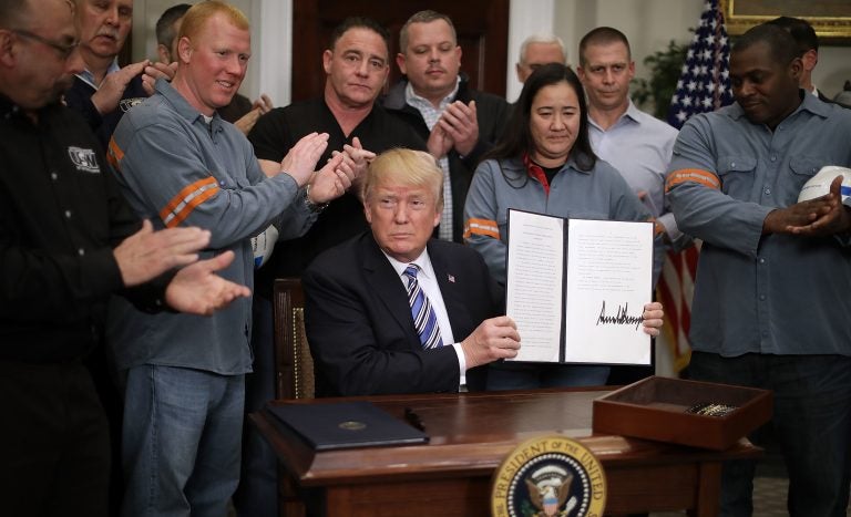 Surrounded by steel and aluminum workers, President Trump holds up the order on steel imports that he signed in Roosevelt Room the the White House on Thursday. Surrounded by steel and aluminum workers, President Trump holds up the order on steel imports that he signed in Roosevelt Room the the White House on Thursday.
(Chip Somodevilla/Getty Images)