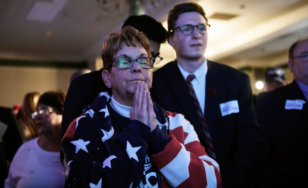 Bobbi Bauer prays during an election night event for Republican congressional candidate Rick Saccone on Tuesday. Saccone narrowly trails Democrat Conor Lamb and has not yet conceded.