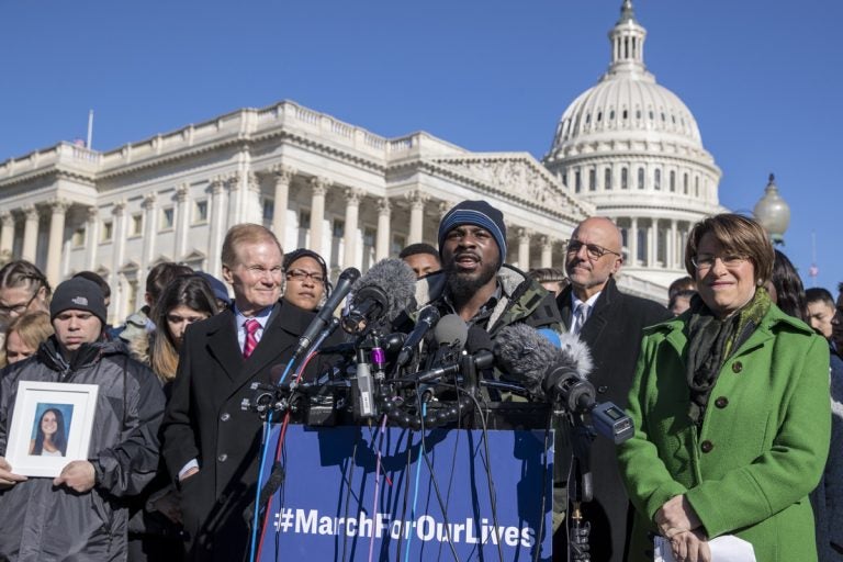 Robert Edwards, center, a student from Washington, speaks alongside lawmakers and gun control activists at the U.S. Capitol