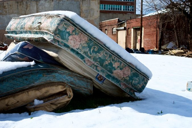 A pile of mattresses on a vacant lot in Strawberry Mansion. (Bastiaan Slabbers/for WHYY)