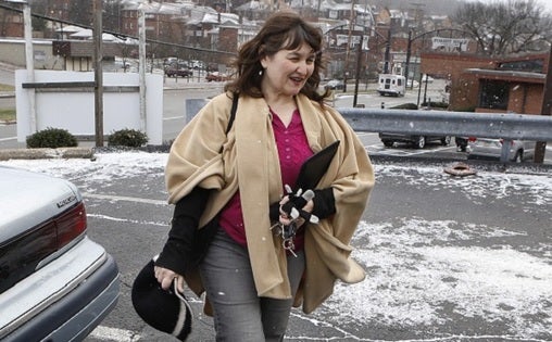 Shelagh Collins walks from her car to a job search appointment on Monday, Dec. 30, 2013, in Forest Hills, Pa., an eastern suburb of Pittsburgh. Collins gets by on occasional secretarial temp work and unemployment compensation checks, but she can't afford specialized treatment for her various health conditions that limit her ability to do certain jobs. (Keith Srakocic/AP Photo)