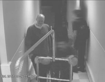 Stephen Paddock smiles as a valet helps him transport luggage to his hotel room on Sept. 26. (MGM Resorts International)