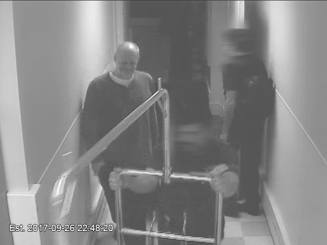 Stephen Paddock smiles as a valet helps him transport luggage to his hotel room on Sept. 26. (MGM Resorts International)