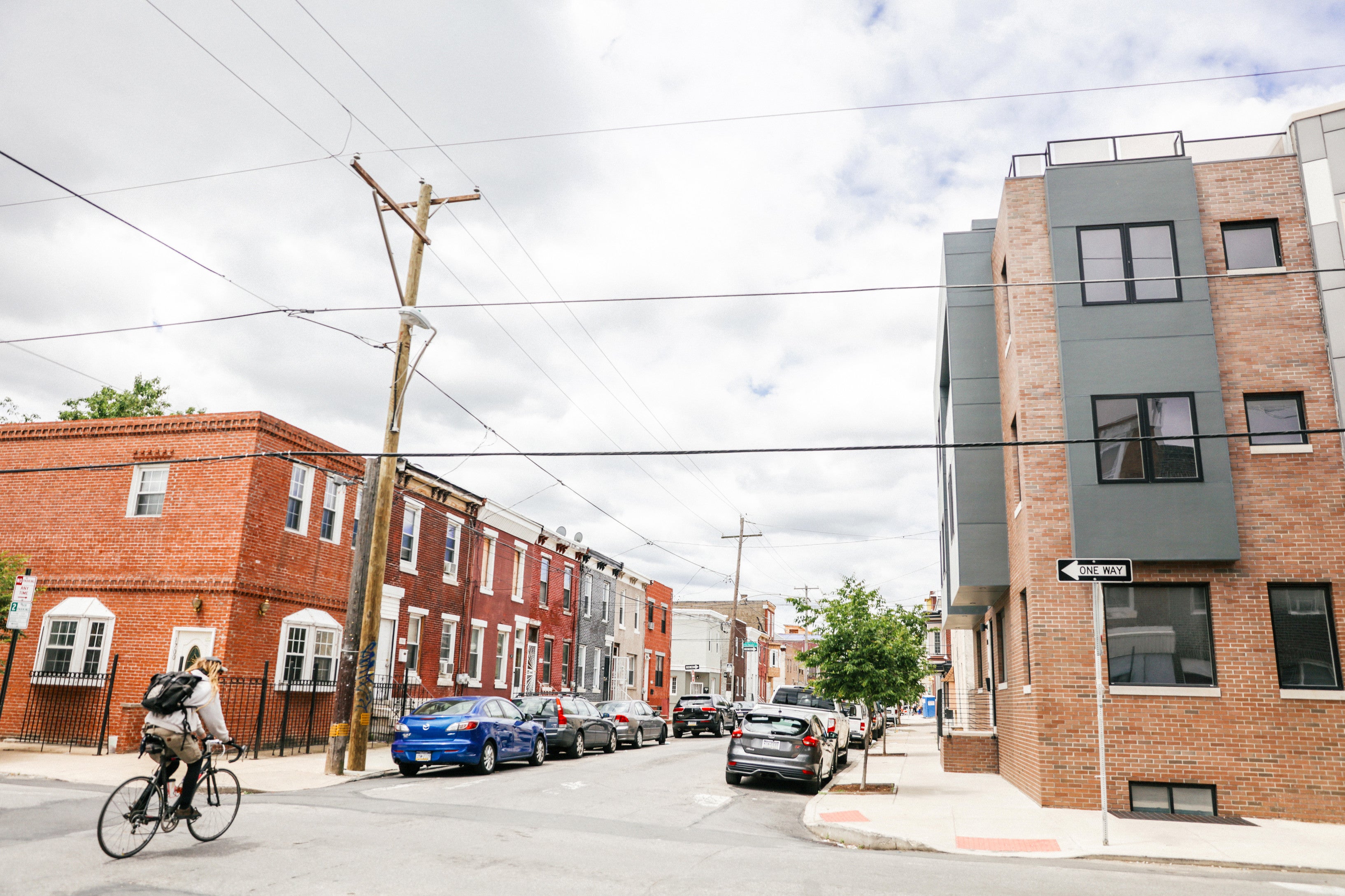 A bicyclist rides down a street in Point Breeze