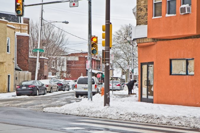 Residents clean up after the snow Thursday morning in West Philadelphia. (Kimberly Paynter/WHYY)