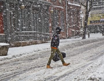 A pedestrian trudges through the storm in Philadelphia Wednesday afternoon. (Kimberly Paynter/WHYY)