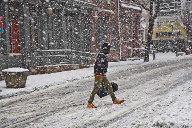A pedestrian trudges through the storm in Philadelphia Wednesday afternoon. (Kimberly Paynter/WHYY)