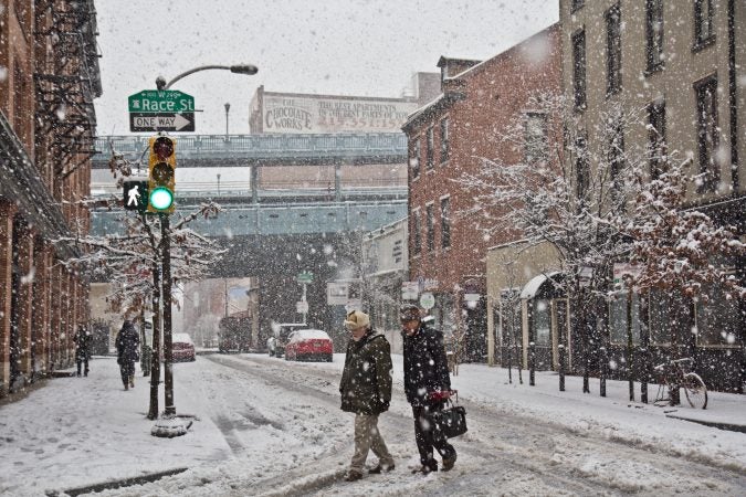 Pedestrian trudge through the storm in Philadelphia Wednesday afternoon. (Kimberly Paynter/WHYY)