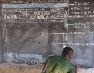 Owura Kwadwo Hottish illustrates a window of Microsoft Word using colored chalk on a blackboard. He uses it to teach computer skills to students at the Betenase M/A Junior High School in Kumasi, Ghana. (Frimpong Innocent)