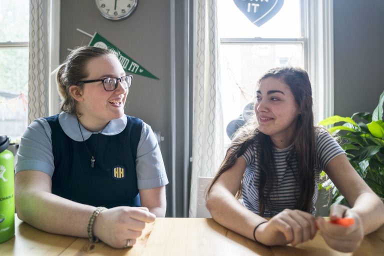 Seventeen-year-olds Maxine Van Osten, left, and Finn Kairer hang out after school in Philadelphia. Both girls have voluntarily reduced their time on their phones and social media. (Jessica Kourkounis for WHYY)