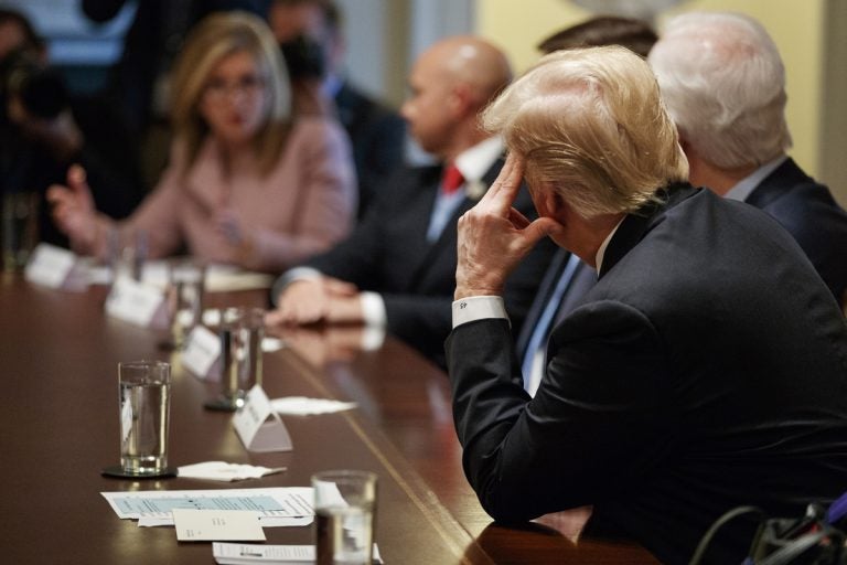 President Donald Trump looks across the table to Rep. Marsha Blackburn, R-Tenn.