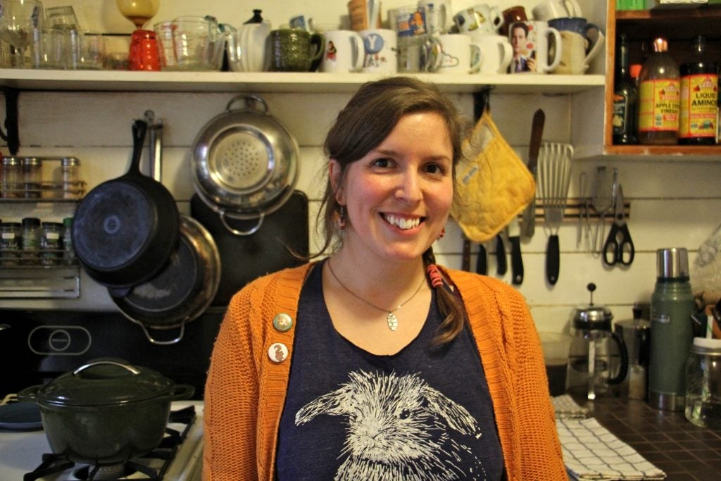 Meghan Adorno stands in her kitchen. She decided to go vegan three years ago. She says now she can really call herself an environmentalist. (Emma Lee/WHYY)