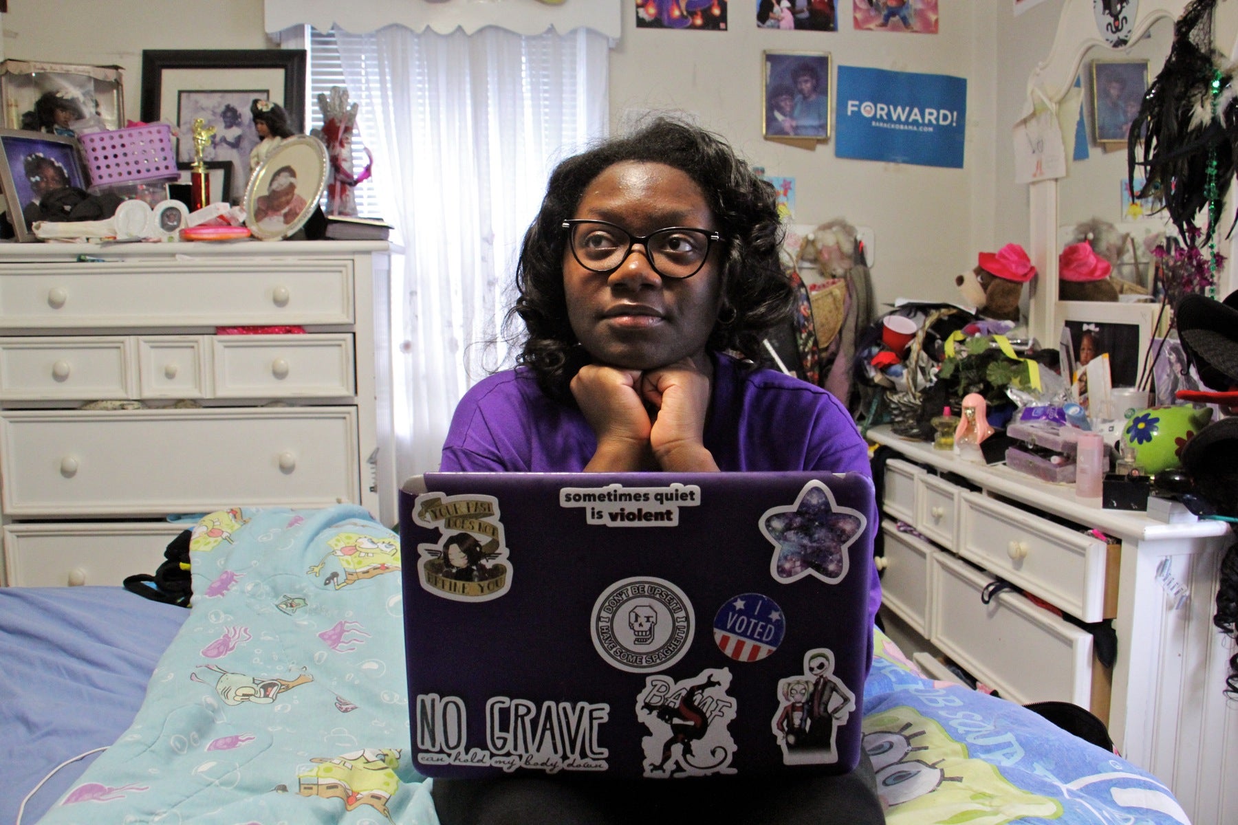 High school junior Jayda Hepburn, sitting in her bedroom, wrote two librettos for "Philadelphia Voices." (Emma Lee/WHYY)