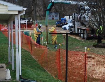 Pipeline workers probe the ground on Lisa Drive in West Whiteland Township where sinkholes have developed as a result of the Mariner East 2 construction. Vandalism to pipeline construction equipment nearby has garnered two separate $10,000 rewards. (Jon Hurdle/StateImpact Pennsylvania)