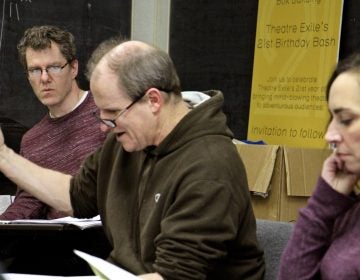 Playwright Michael Hollinger (left) listens to a first read of a new script during rehearsal for his drama, 