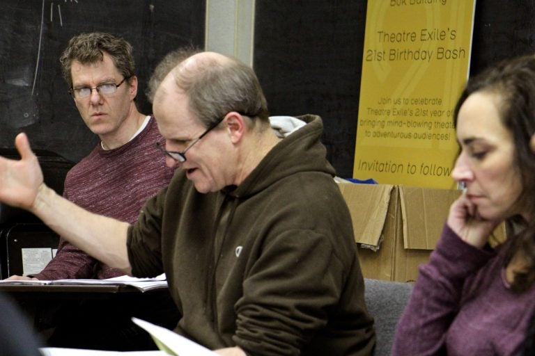 Playwright Michael Hollinger (left) listens to a first read of a new script during rehearsal for his drama, 