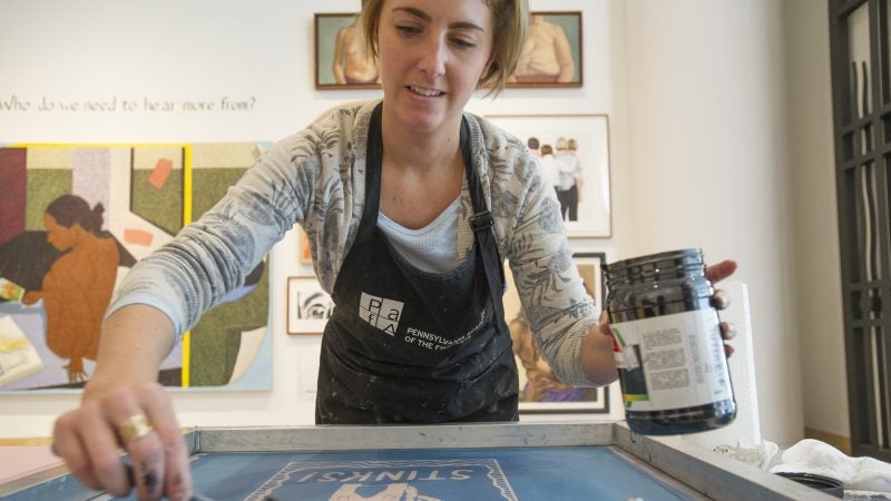 Alyssa Ebinger, an MFA student, prepares a silk screen for printing. (Jonathan Wilson for WHYY)