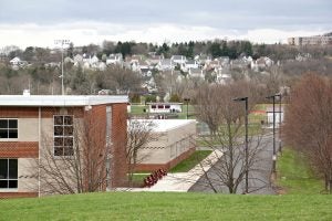 Homes rise on the hills around Pottsgrove High School. Like many school districts in Pennsylvania, Pottsgrove works to ensure that its students are residents and disenrolls those who are not. (Emma Lee/WHYY)