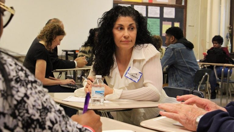 File photo: Philadelphia school board member Maria McColgan hears from community members during a listening session at Dobbins High School. (Emma Lee/WHYY)