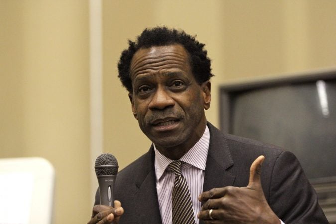 Philadelphia school board member Wayne Walker speaks at a community meeting at Dobbins High School. (Emma Lee/WHYY)