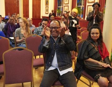 Dr. Tony Monteiro applauds during 