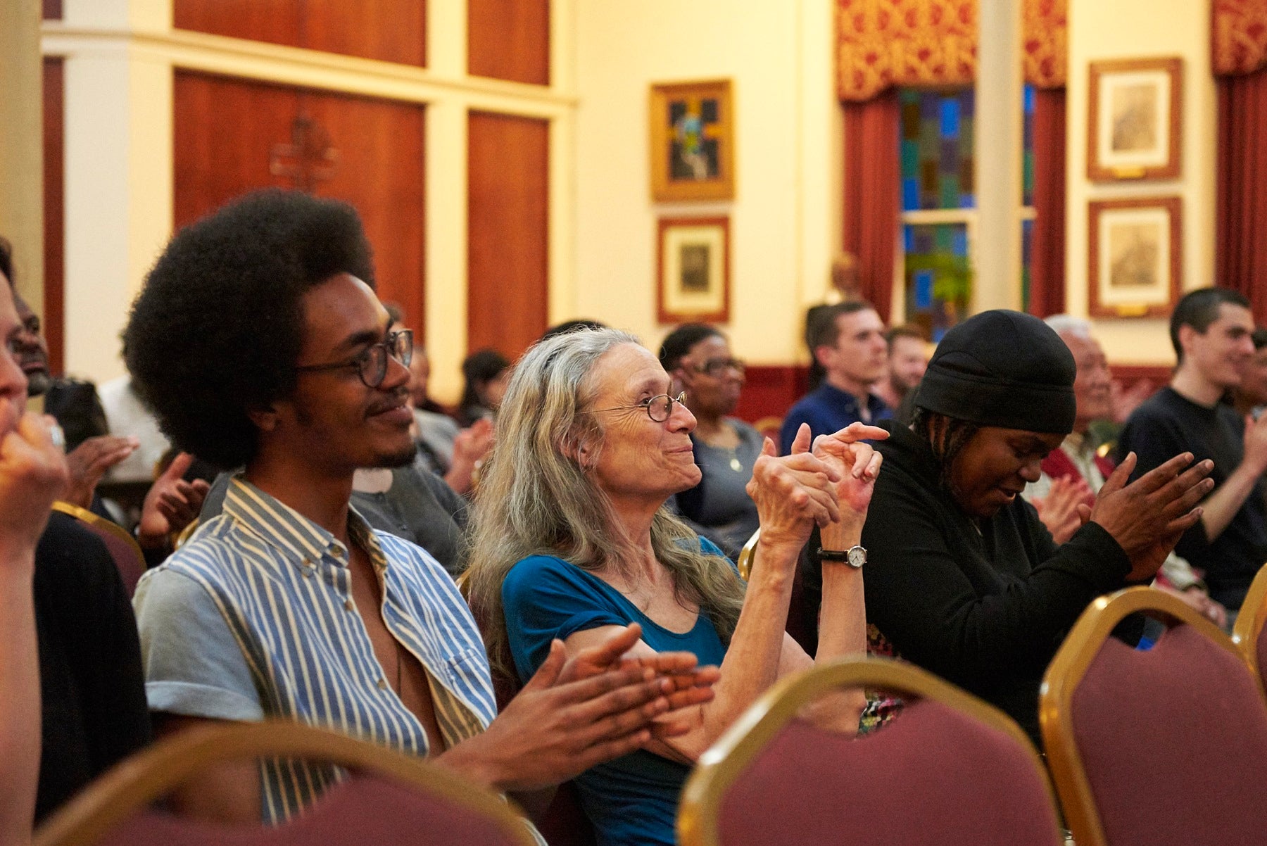 Audience members applaud performers at "Blessed are the Peacemakers."