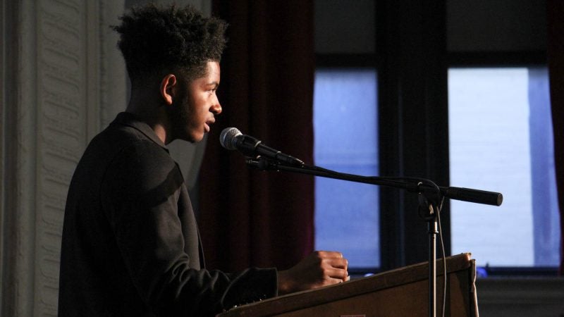 Student leader Ahmad Abdullah-Tucker makes an impassioned plea for community members to work together to end gun violence. (Emma Lee/WHYY)