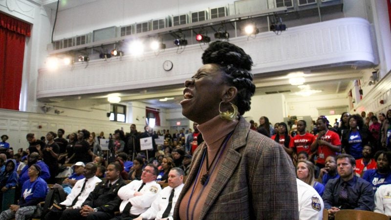 Dominique London weeps as she calls out the names of stuldents killed by gun violence during an assembly at Mastery Shoemaker charter school (Emma Lee/WHYY)