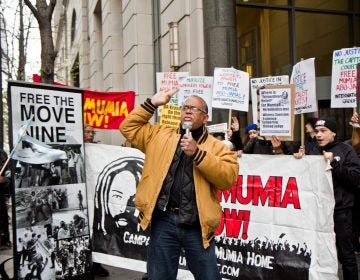 Zayid Muhammad leads a rally for the release of Mumia Abu-Jamal outside the Philadelphia Criminal Justice Center Monday morning. (Kimberly Paynter/WHYY)