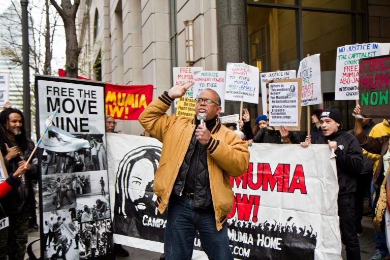 Zayid Muhammad leads a rally for the release of Mumia Abu-Jamal outside the Philadelphia Criminal Justice Center Monday morning. (Kimberly Paynter/WHYY)