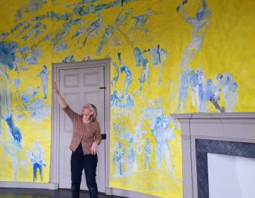 Artist Jane Irish explains how she painted one of the oval rooms in the Lemon Hill mansion to depict an anti-war demonstration that took place in Valley Forge, in 1970. (Peter Crimmins/WHYY)