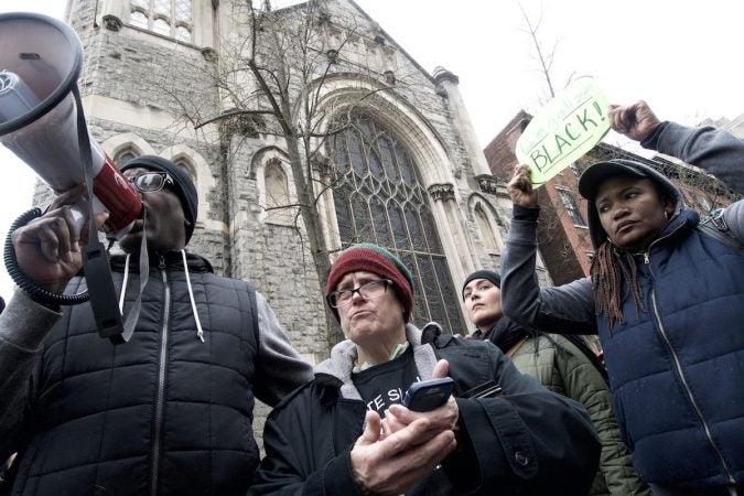 People gather outside a Starbucks on 18th and Spruce streets in Philadelphia to protest Thursday's controversial arrests of two black men at the store. (Bastiaan Slabbers/for WHYY)