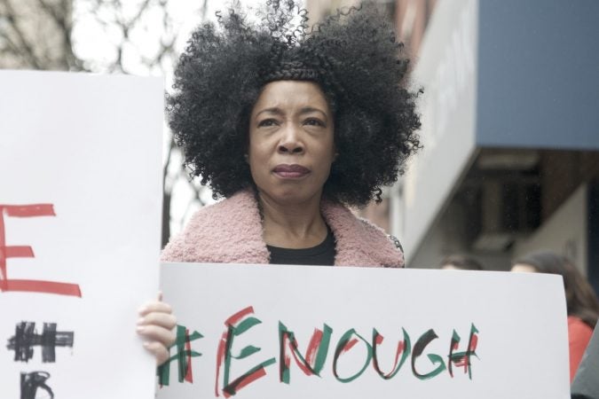 A protester takes part in a demonstration outside a Starbucks on 18th and Spruce streets in Philadelphia to protest Thursday's controversial arrests of two black men at the store. (Bastiaan Slabbers/for WHYY)