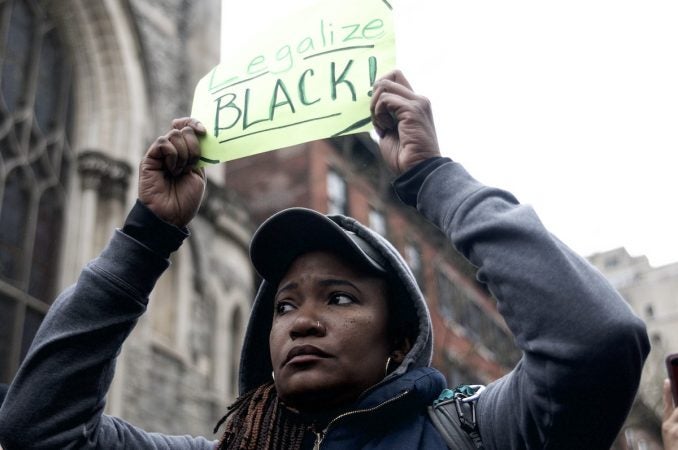 People gather outside a Starbucks on 18th and Spruce streets in Philadelphia to protest Thursday's controversial arrests of two black men at the store. (Bastiaan Slabbers/for WHYY)