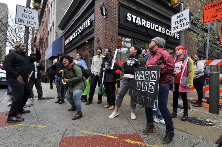 About 50 protesters gathered inside the Starbucks near Rittenhouse Square on Monday morning to protest the recent arrest of two black men. (Bastiaan Slabbers for WHYY)