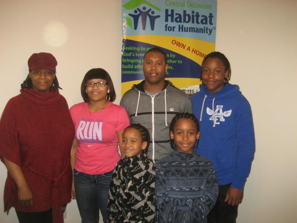 Yolanda Knight (far left) moved her from public housing and bought a home with the help of Habitat for Humanity. Will, then 13, is at far right in blue sweatshirt. (Courtesty of Habitat for Humanity of Kent County)