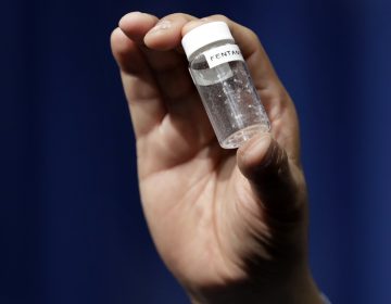 In this June 6, 2017 file photo, a reporter holds up an example of the amount of fentanyl that can be deadly after a news conference about deaths from fentanyl exposure, at DEA Headquarters in Arlington Va. (Jacquelyn Martin/AP Photo, File)